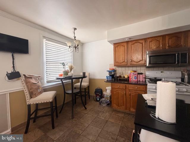 7206 Montague Street Philadelphia, PA 19135 - Photo 7 of 15 a kitchen with sink cabinets and microwave