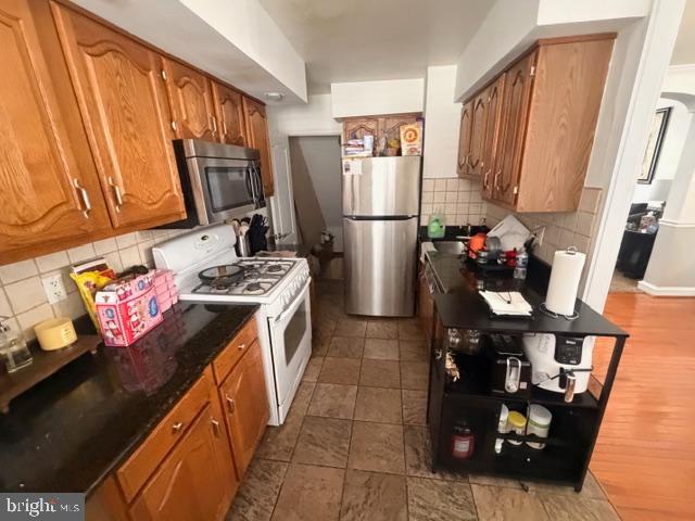 7206 Montague Street Philadelphia, PA 19135 - Photo 8 of 15 a kitchen with stainless steel appliances granite countertop a refrigerator stove and sink