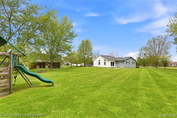 12265 Hough Road Memphis, MI 48041 - Photo 32 of 41 View of grassy yard featuring a playground