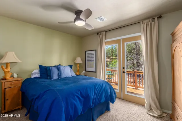 a bedroom with a large bed and a large window