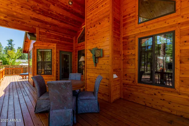 a view of a patio with table and chairs and wooden floor