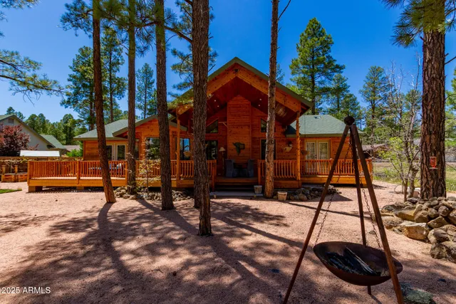 a backyard of a house with barbeque oven table and chairs