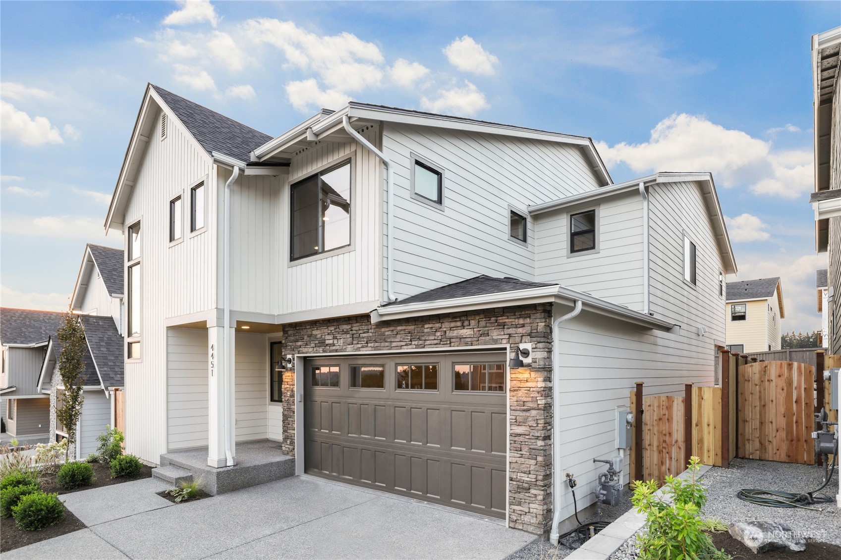 4418 242nd Place Southeast, Unit SL 25 Bothell, WA 98021 - Photo 2 of 36 a front view of a house with a garage