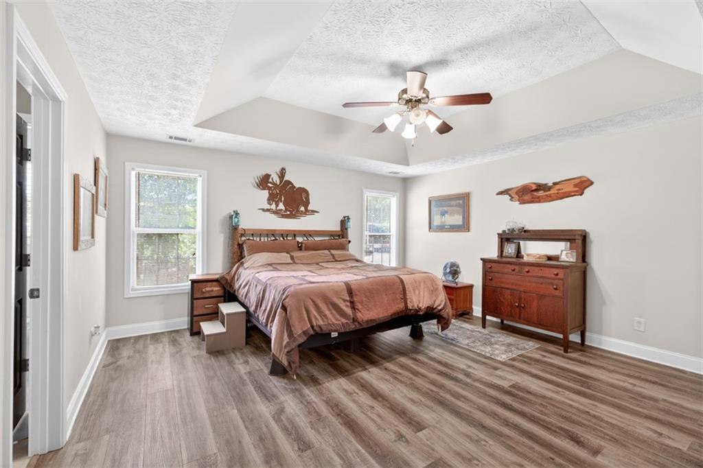 89 Katie Spring Lane Jefferson, GA 30549 - Photo 34 of 63 a bedroom with a bed and a dresser
