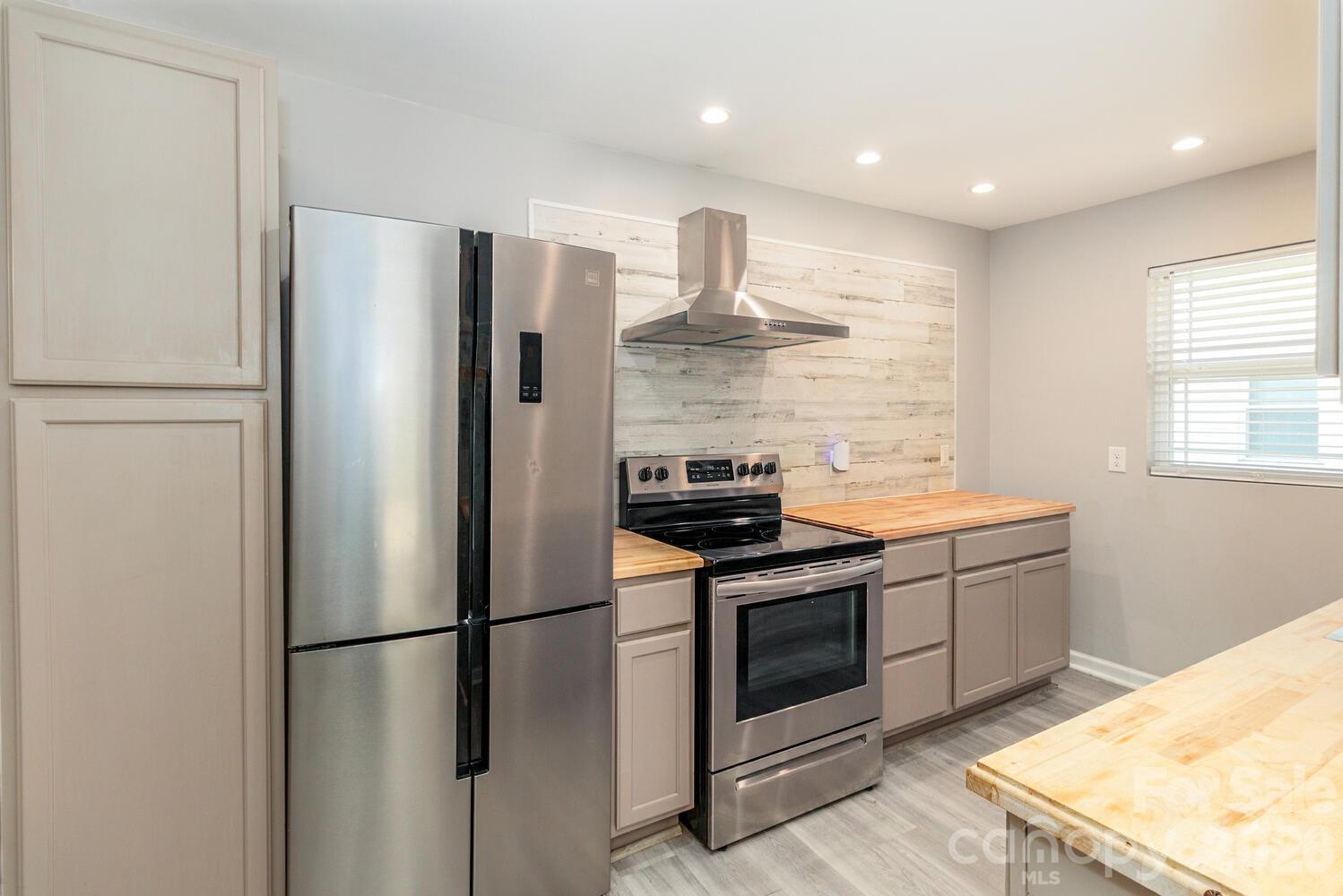 304 Bell Street Kannapolis, NC 28081 - Photo 11 of 27 a kitchen with stainless steel appliances granite countertop a refrigerator a stove and a sink