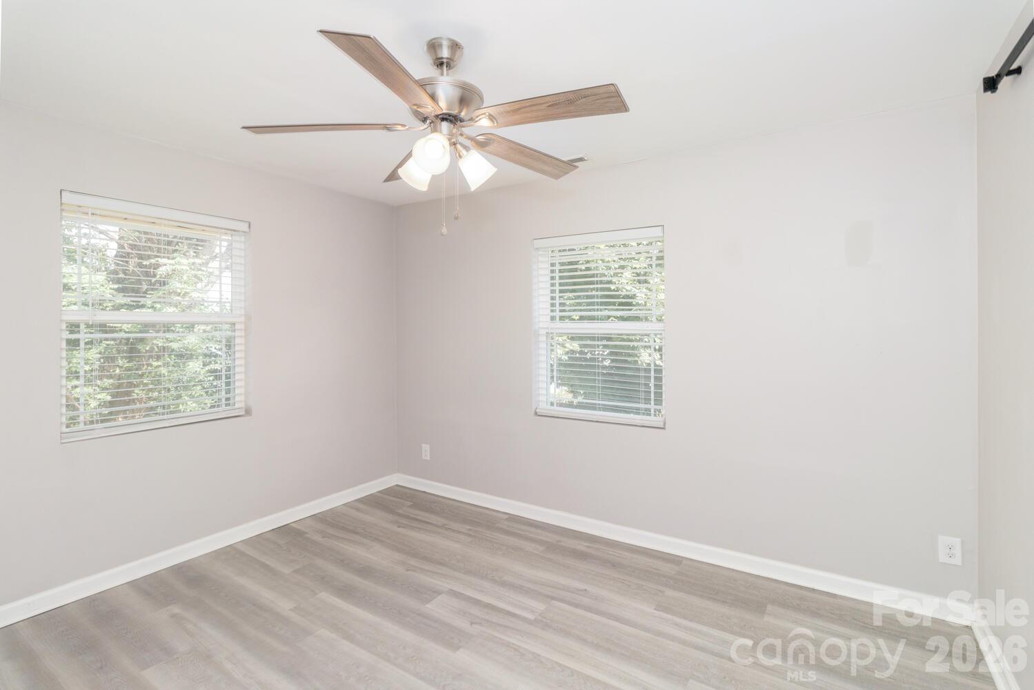 304 Bell Street Kannapolis, NC 28081 - Photo 13 of 27 a view of an empty room with wooden floor and a window