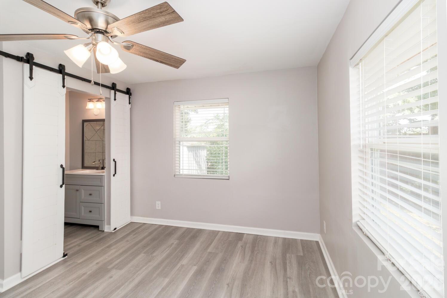 304 Bell Street Kannapolis, NC 28081 - Photo 15 of 27 a view of an empty room with a window and a ceiling fan