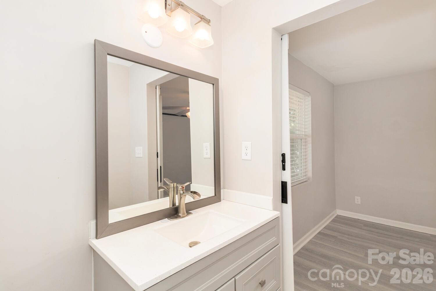 304 Bell Street Kannapolis, NC 28081 - Photo 19 of 27 a bathroom with a sink and a mirror