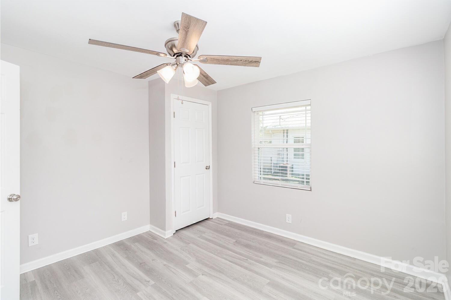 304 Bell Street Kannapolis, NC 28081 - Photo 24 of 27 an empty room with a window and a fan