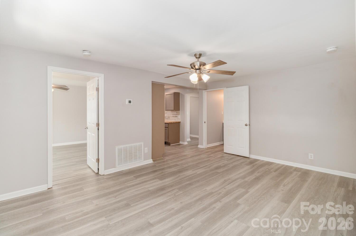 304 Bell Street Kannapolis, NC 28081 - Photo 4 of 27 a view of an empty room with wooden floor