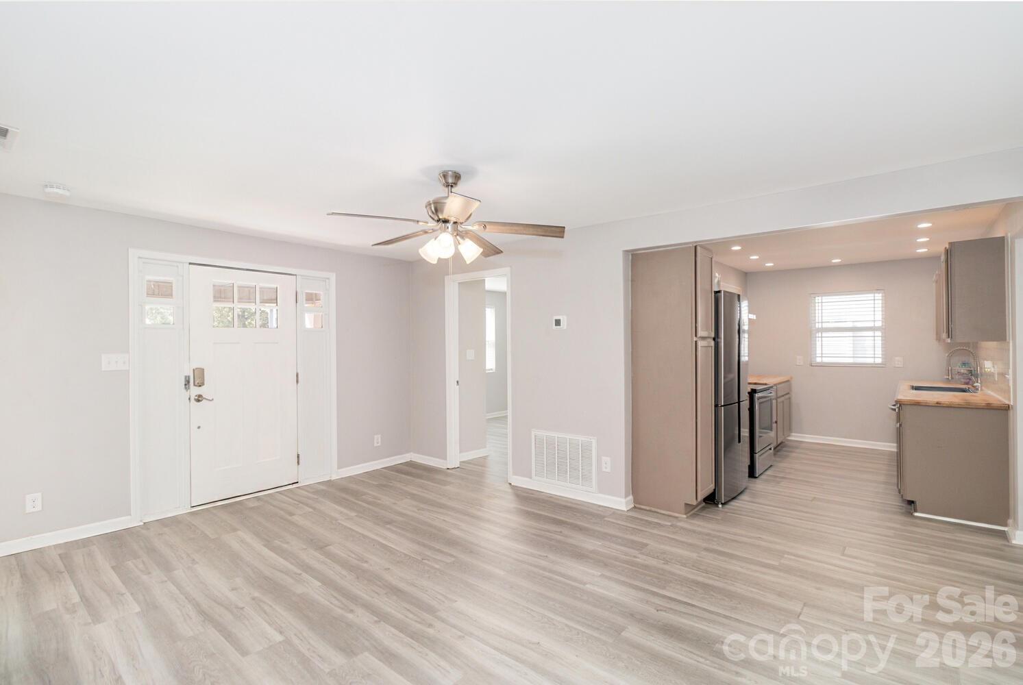 304 Bell Street Kannapolis, NC 28081 - Photo 6 of 27 a view of a big room with wooden floor and windows