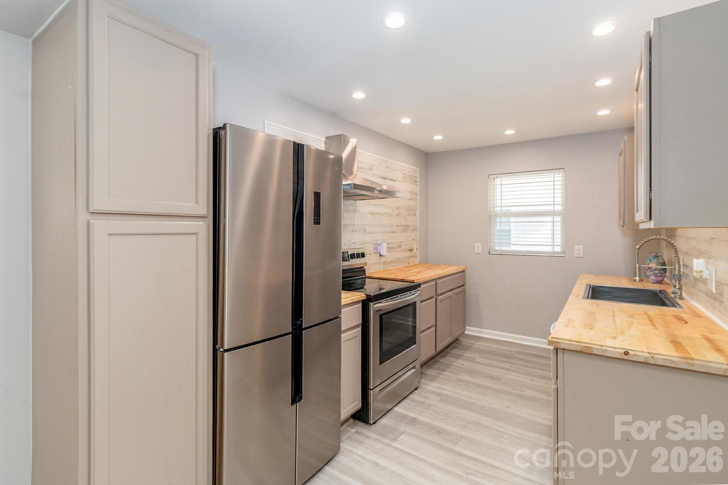 304 Bell Street Kannapolis, NC 28081 - Photo 7 of 27 a kitchen with granite countertop a refrigerator stove and sink