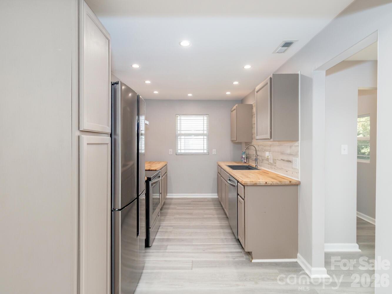 304 Bell Street Kannapolis, NC 28081 - Photo 8 of 27 a view of a kitchen with a sink and cabinets