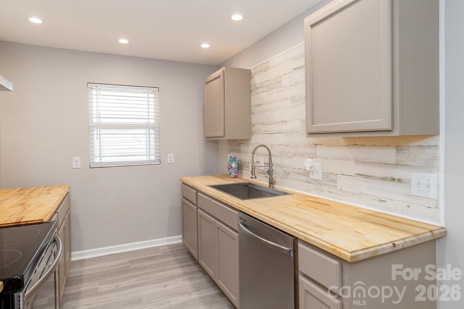 304 Bell Street Kannapolis, NC 28081 - Photo 9 of 27 a kitchen with a sink stove and cabinets