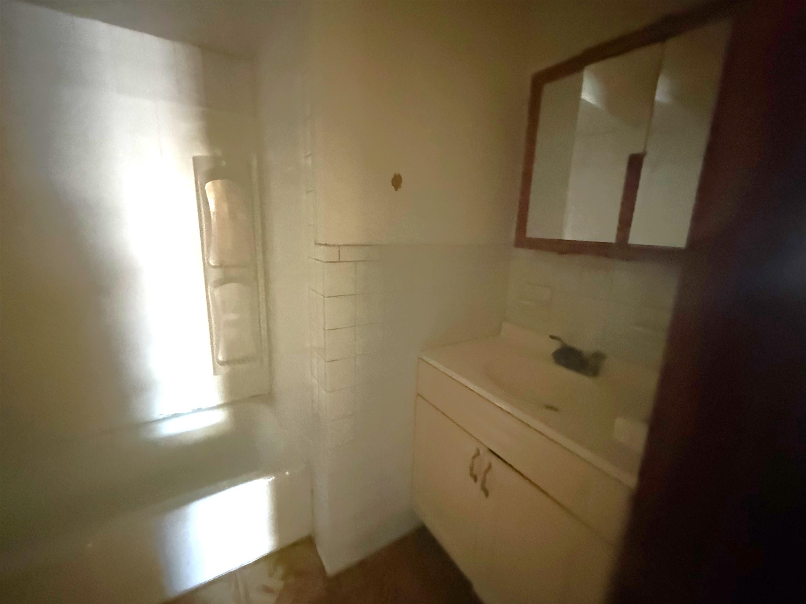 910-912 Broadway, Unit 3 Bayonne, NJ 07002 - Photo 9 of 10 a bathroom with a sink and a mirror