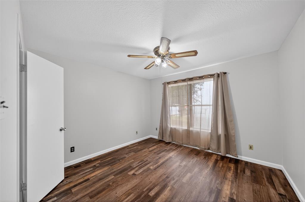 23363 Wateridge Loop Flint, TX 75762 - Photo 29 of 40 wooden floor in an empty room with a window