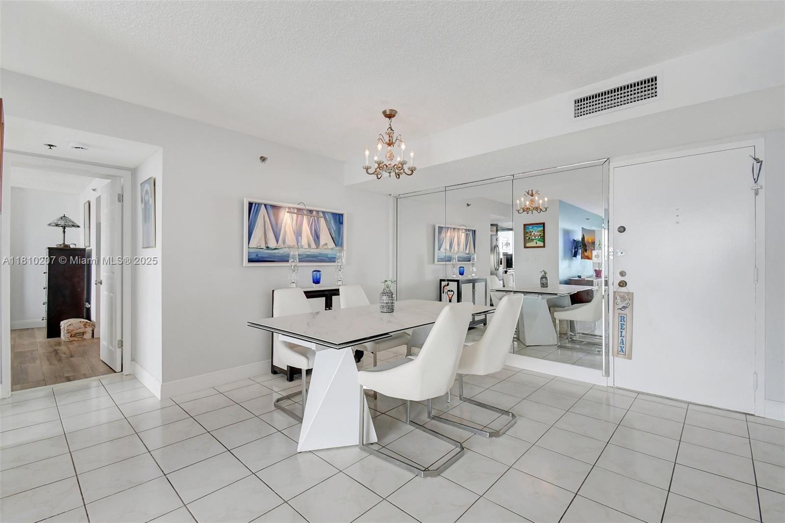 210 174th Street, Unit 2212 Sunny Isles Beach, FL 33160 - Photo 14 of 39 a view of a dining room with furniture