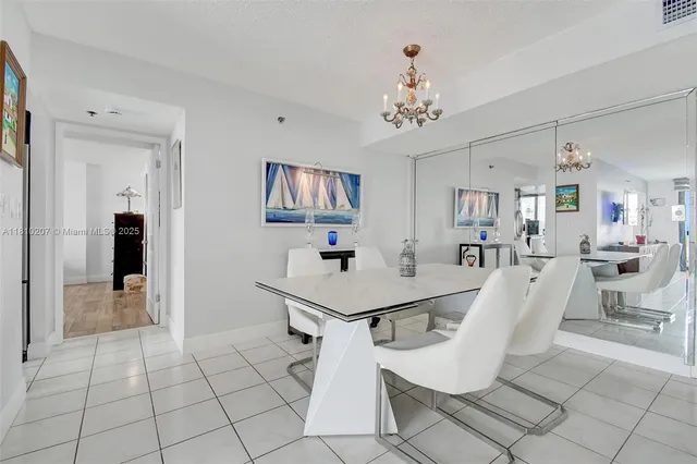 a view of a room with furniture and chandelier
