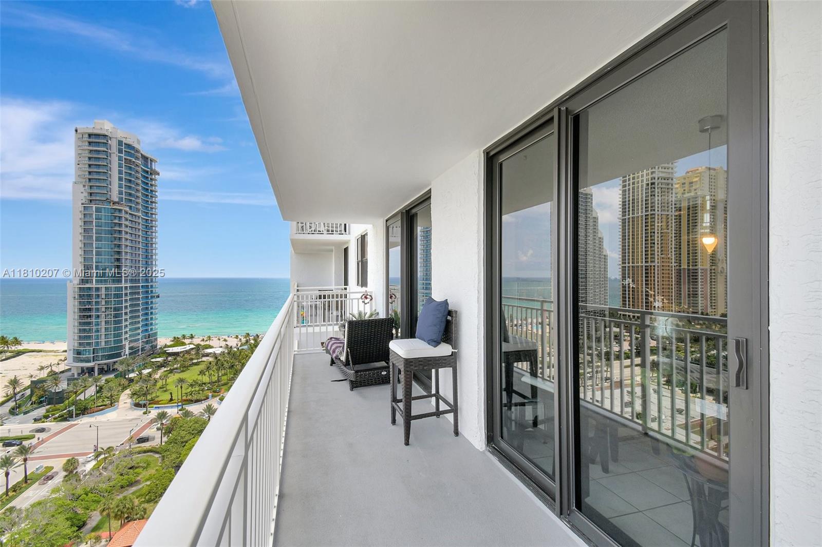 210 174th Street, Unit 2212 Sunny Isles Beach, FL 33160 - Photo 23 of 39 a balcony with table and chairs
