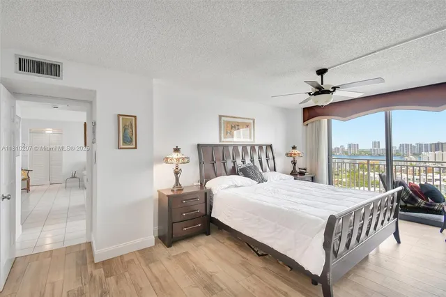 a bedroom with a large bed and a large window