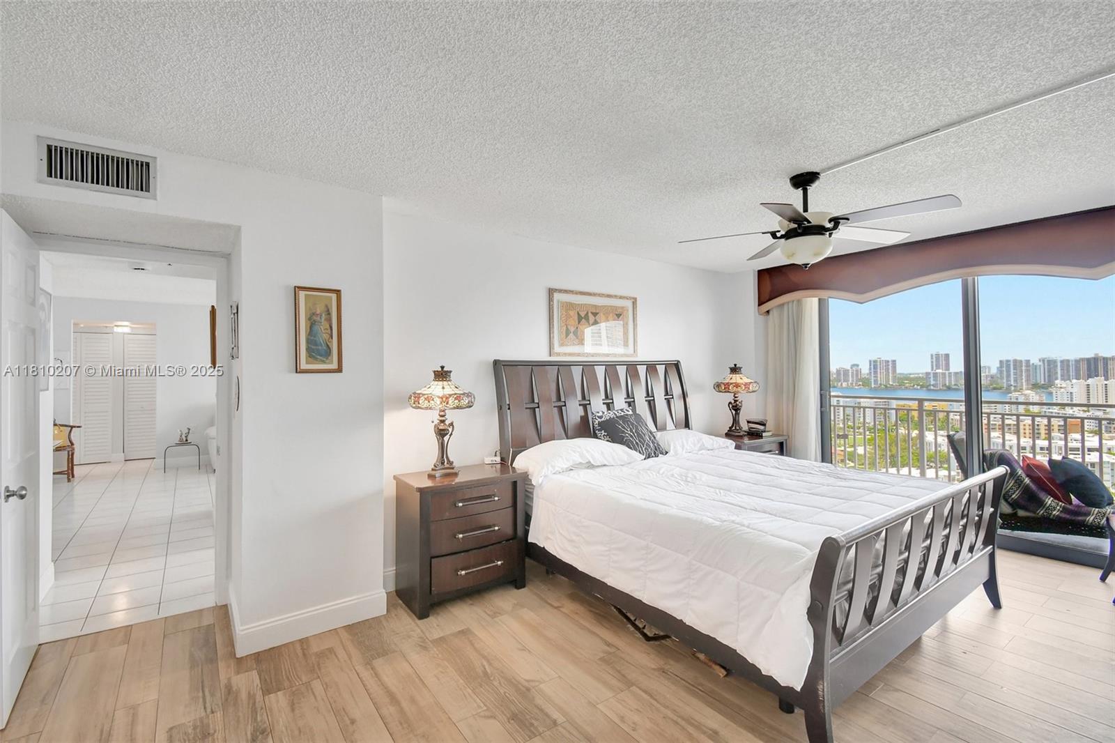 210 174th Street, Unit 2212 Sunny Isles Beach, FL 33160 - Photo 25 of 39 a bedroom with a large bed and a large window