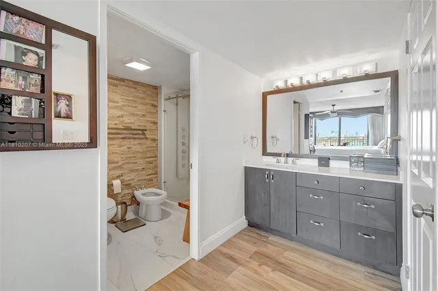 a bathroom with a granite countertop sink mirror and