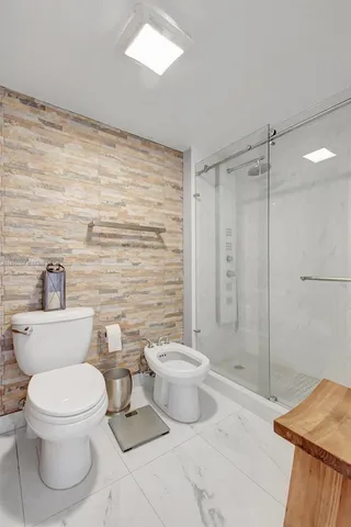 a bathroom with a toilet sink and shower