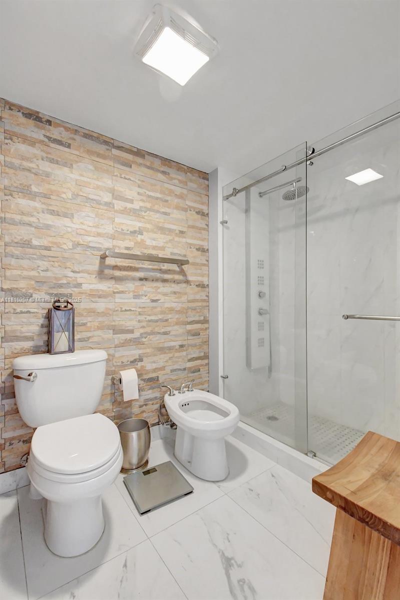 210 174th Street, Unit 2212 Sunny Isles Beach, FL 33160 - Photo 30 of 39 a bathroom with a toilet sink and shower