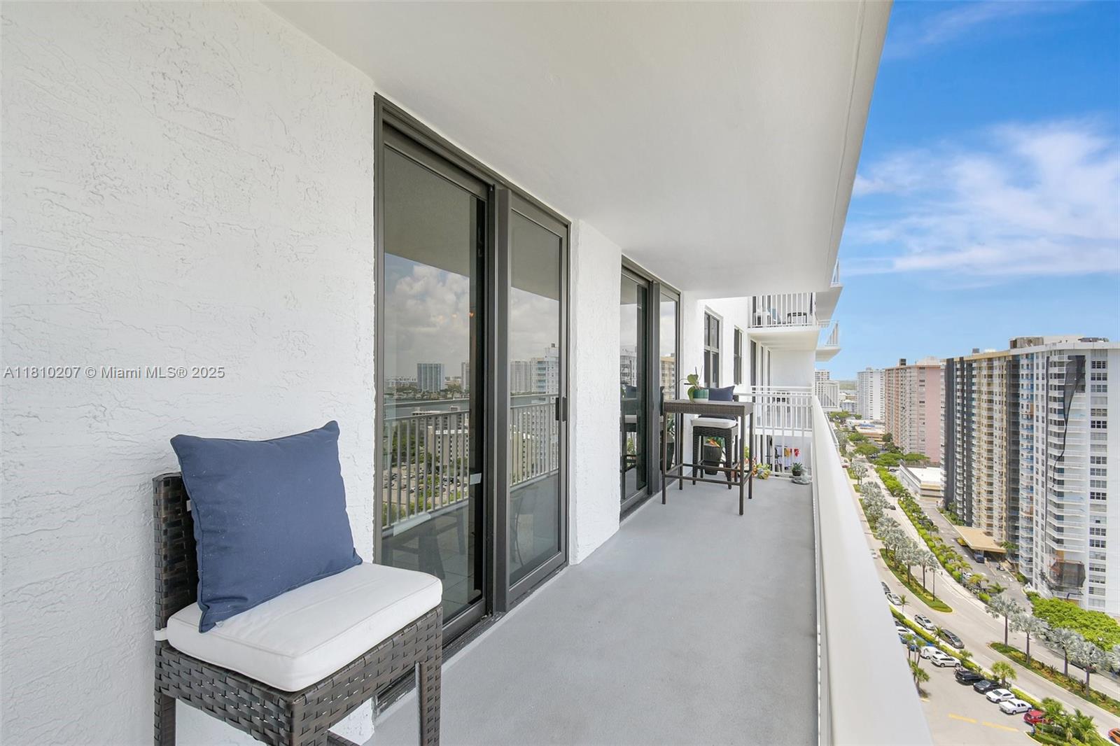 210 174th Street, Unit 2212 Sunny Isles Beach, FL 33160 - Photo 3 of 39 a balcony with furniture and city view