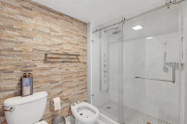a bathroom with a toilet and a shower