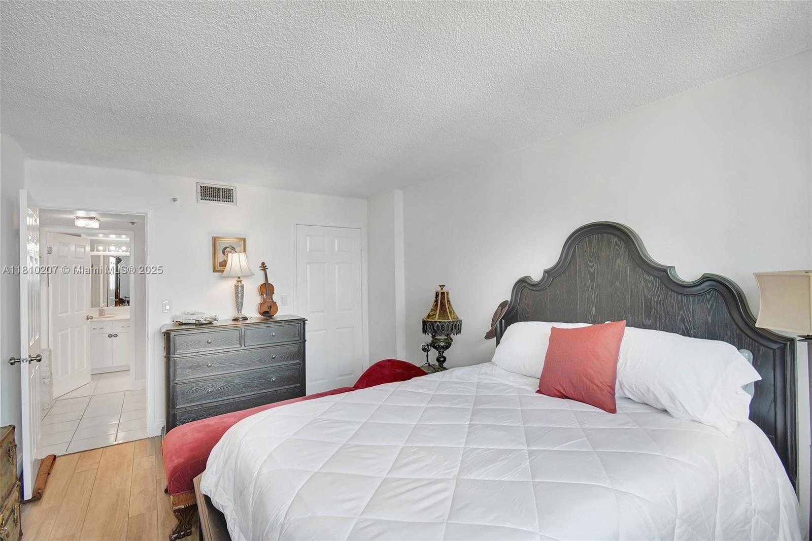 210 174th Street, Unit 2212 Sunny Isles Beach, FL 33160 - Photo 33 of 39 a bedroom with a bed and a dresser