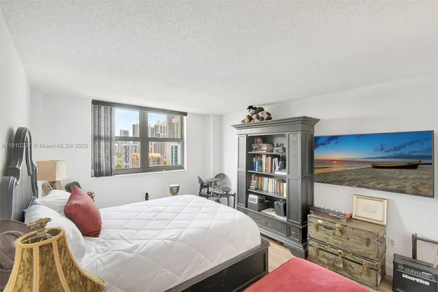 a bedroom with a bed dresser and a window