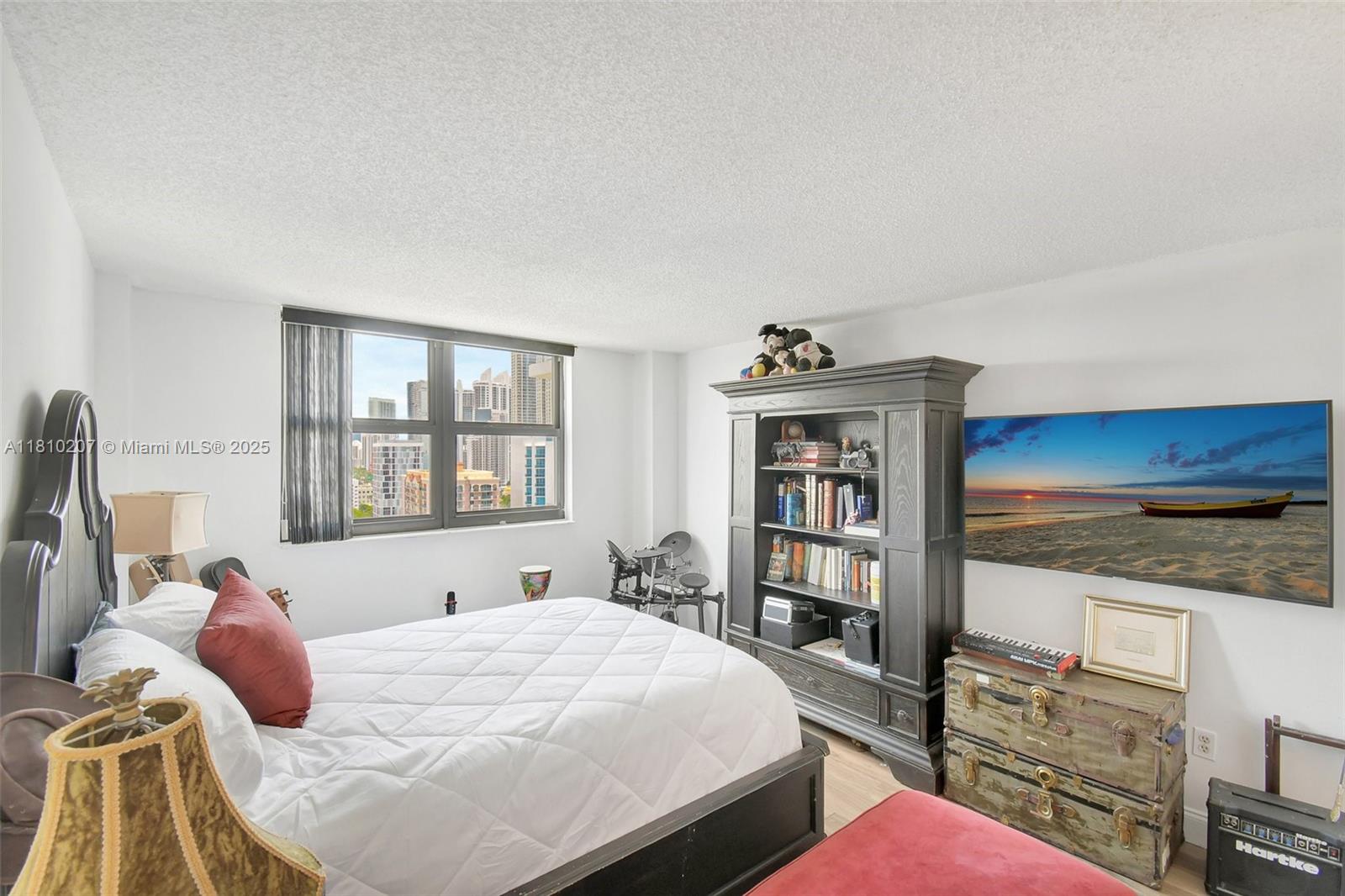 210 174th Street, Unit 2212 Sunny Isles Beach, FL 33160 - Photo 34 of 39 a bedroom with a bed dresser and a window