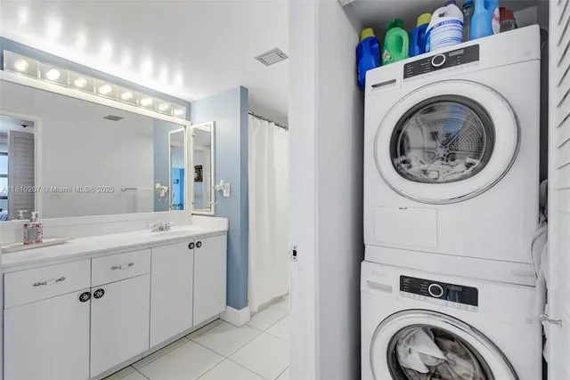 a view of a storage and utility room with washer and dryer
