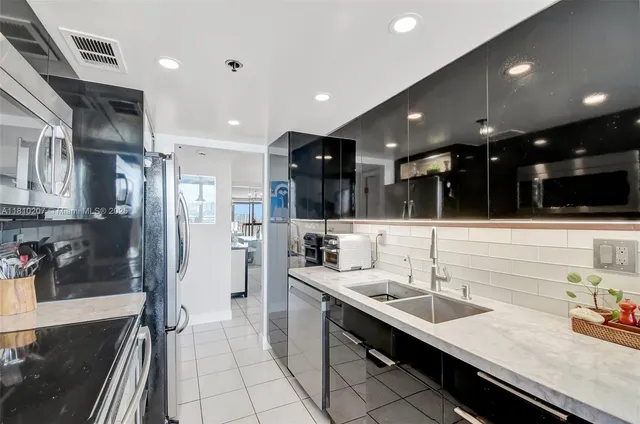 a bathroom with a sink a large mirror and shower