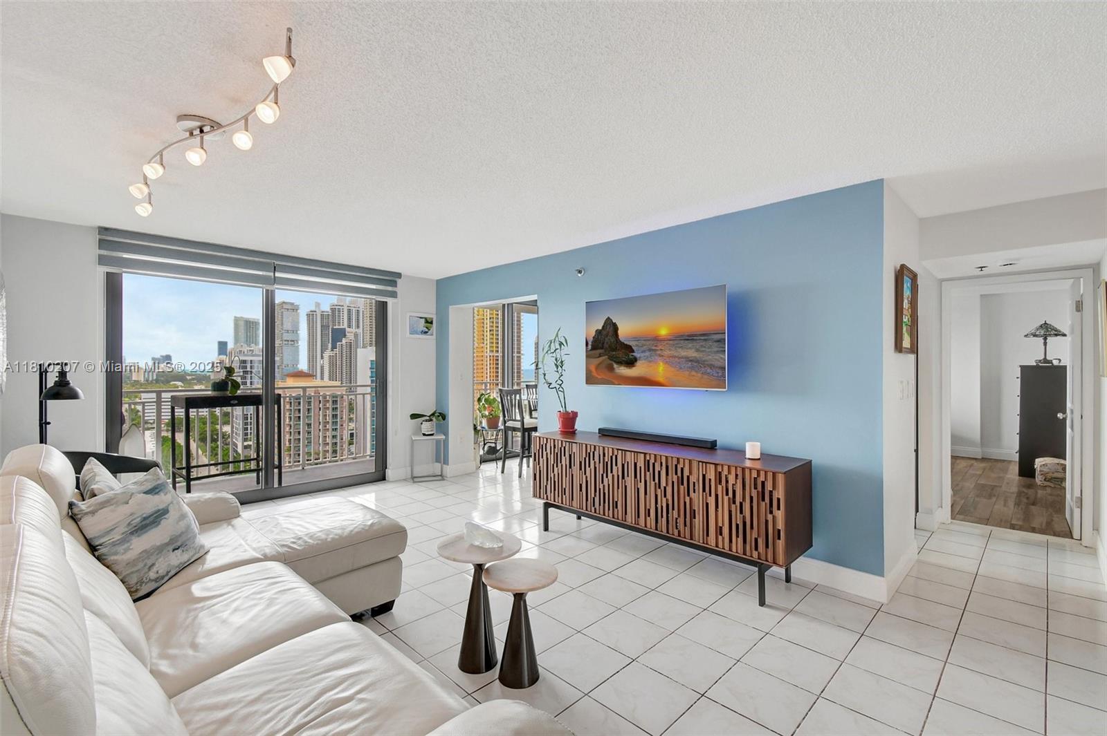 210 174th Street, Unit 2212 Sunny Isles Beach, FL 33160 - Photo 8 of 39 a living room with furniture and a flat screen tv