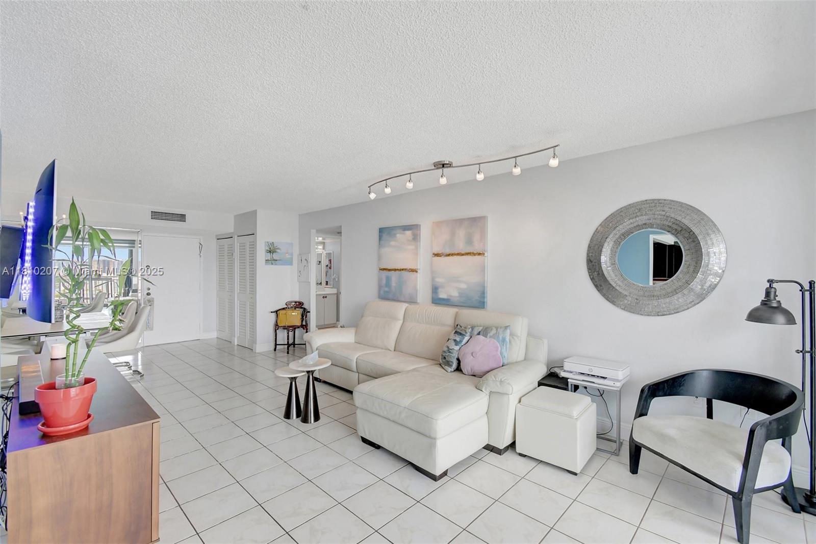 210 174th Street, Unit 2212 Sunny Isles Beach, FL 33160 - Photo 10 of 39 a living room with furniture and a large window