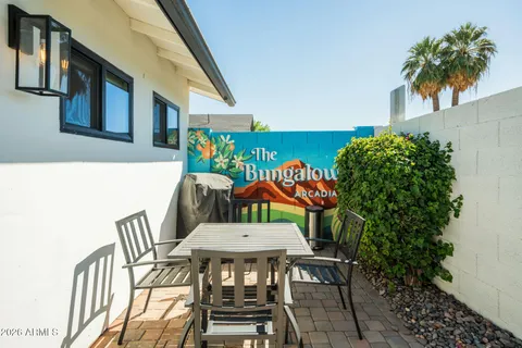 a view of a chairs and table in patio