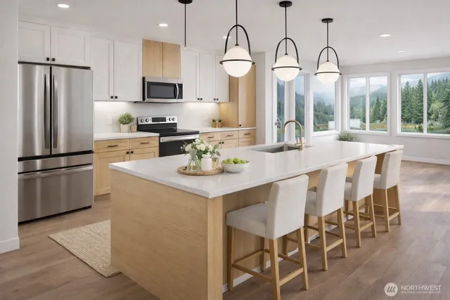 a kitchen with stainless steel appliances granite countertop a stove a sink dishwasher a refrigerator with a dining table and chairs