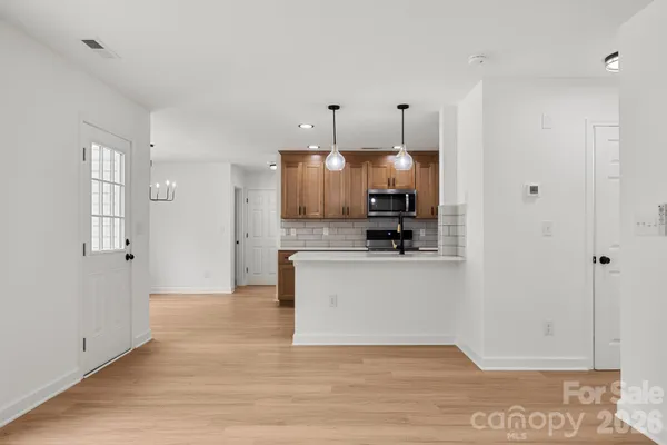 a view of a kitchen with wooden floor