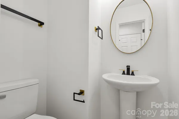 a bathroom with a sink a mirror and a toilet