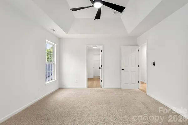 a bathroom with a sink a toilet a window and vanity