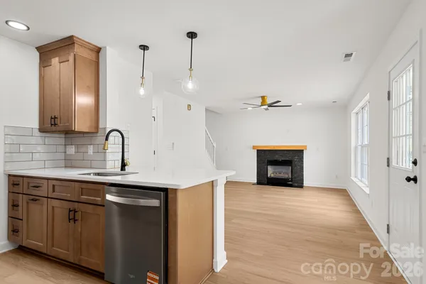 a view of a kitchen with a sink and a fireplace
