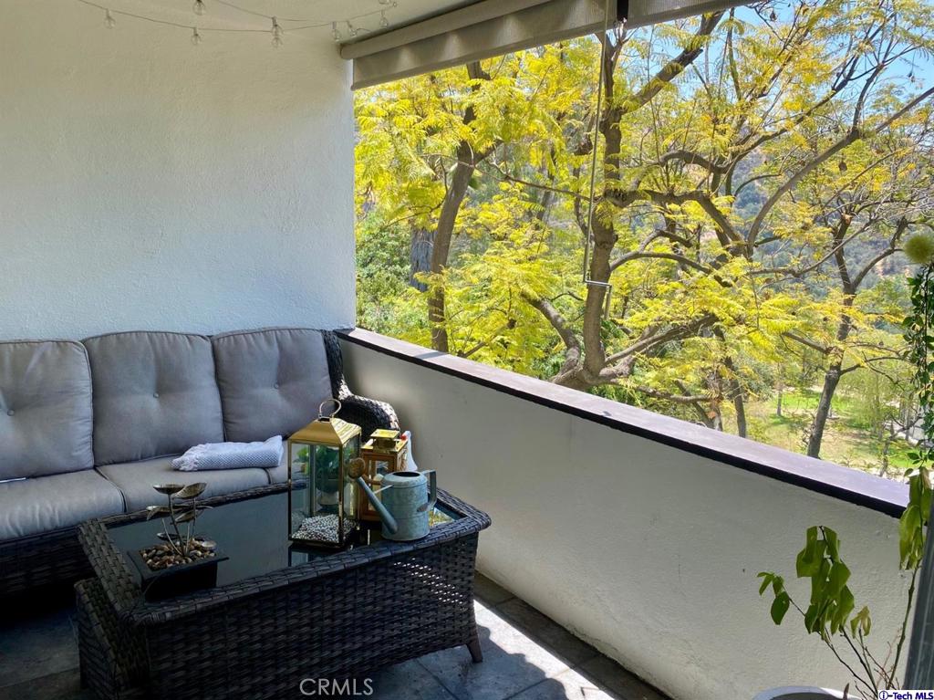 1935 Alpha Road, Unit 328 Glendale, CA 91208 - Photo 12 of 16 a living room with furniture and a large window