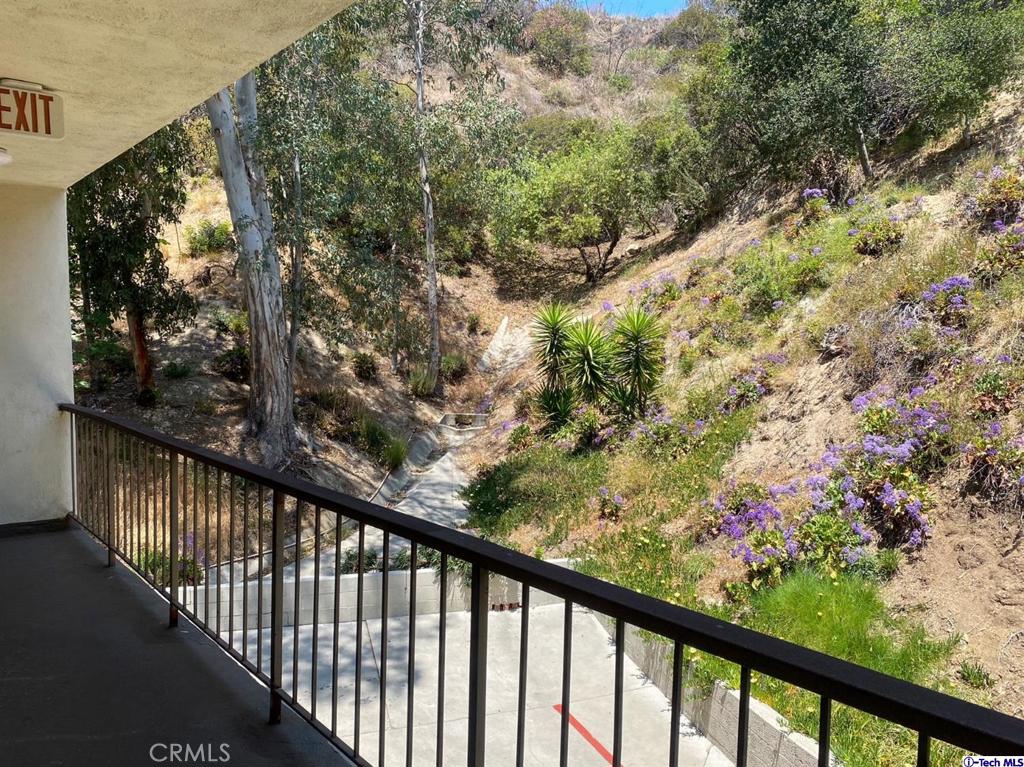 1935 Alpha Road, Unit 328 Glendale, CA 91208 - Photo 13 of 16 a view of a balcony with flower plants