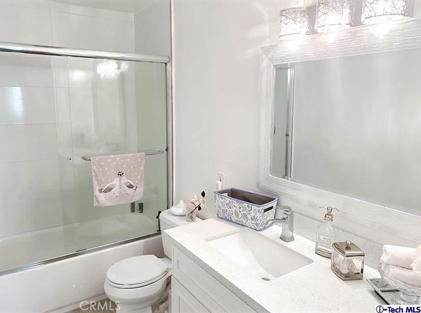 1935 Alpha Road, Unit 328 Glendale, CA 91208 - Photo 9 of 16 a bathroom with a sink a toilet and shower