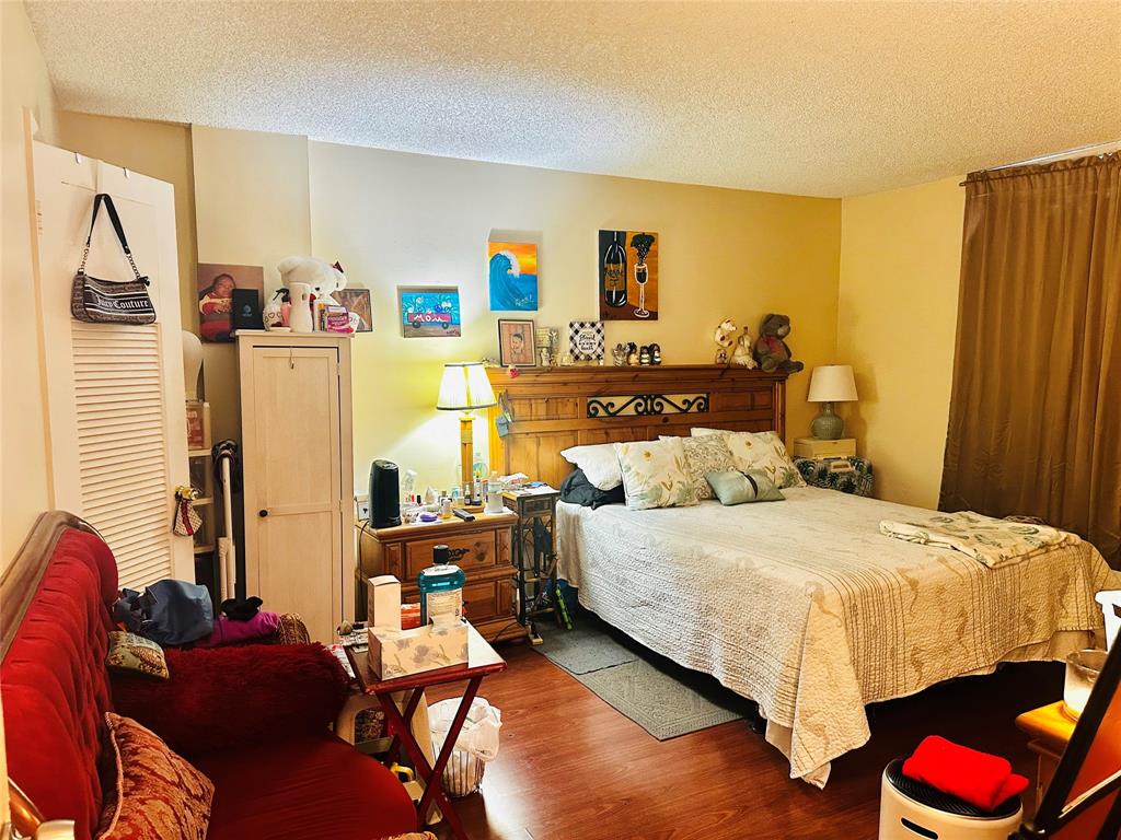 3070 Northwest 48th Terrace, Unit 307 Lauderdale Lakes, FL 33313 - Photo 4 of 13 a bedroom with a bed and a couch