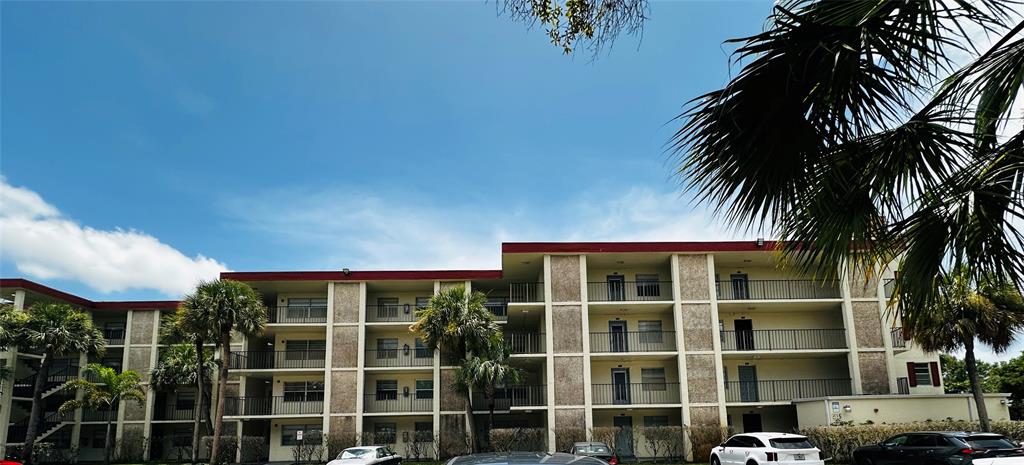 3070 Northwest 48th Terrace, Unit 307 Lauderdale Lakes, FL 33313 - Photo 5 of 13 a view of a house with a yard and potted plants