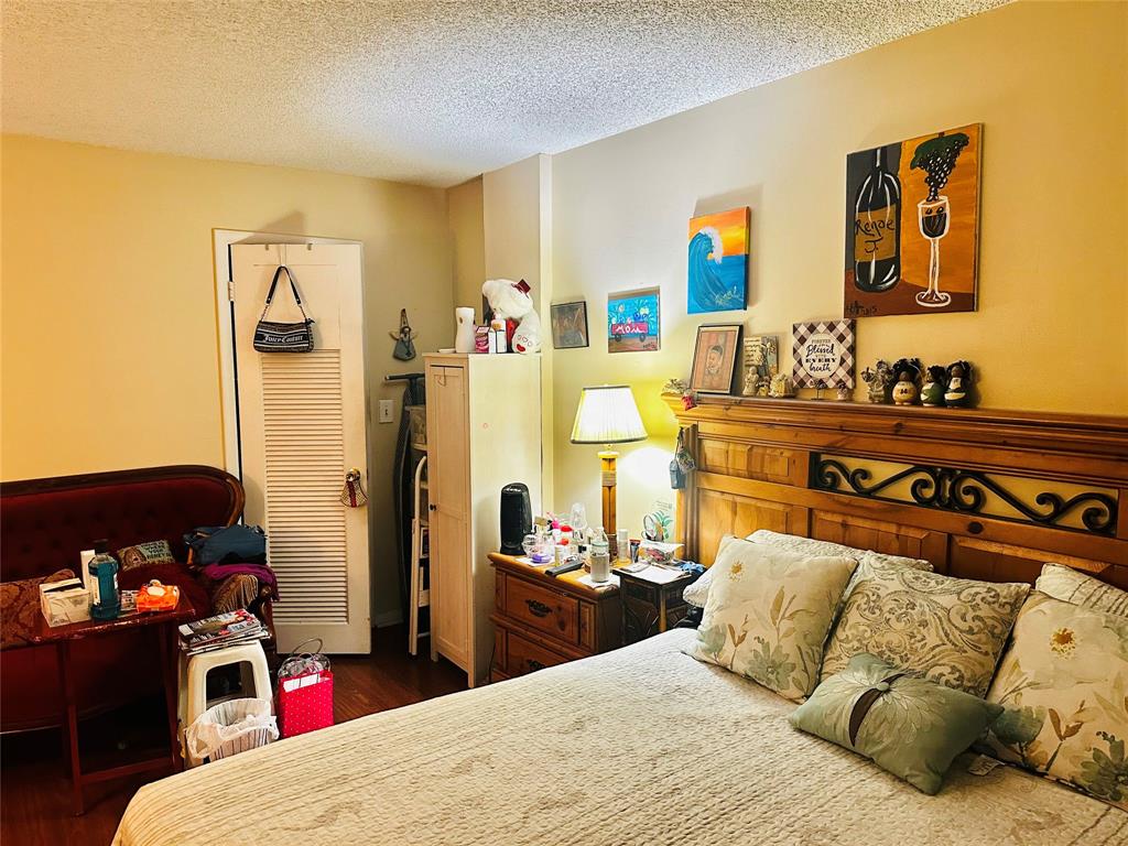 3070 Northwest 48th Terrace, Unit 307 Lauderdale Lakes, FL 33313 - Photo 7 of 13 a bedroom with a bed and dresser