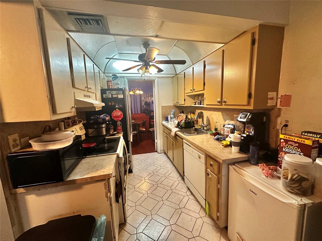 3070 Northwest 48th Terrace, Unit 307 Lauderdale Lakes, FL 33313 - Photo 10 of 13 a kitchen with a sink and a stove top oven